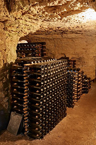 Bottles of sparkling wine ageing in cellar of Domaine de la Taille aux Loups which has been dug out of the tuffeau subsoil Husseau IndreetLoire France  MontlouissurLoire