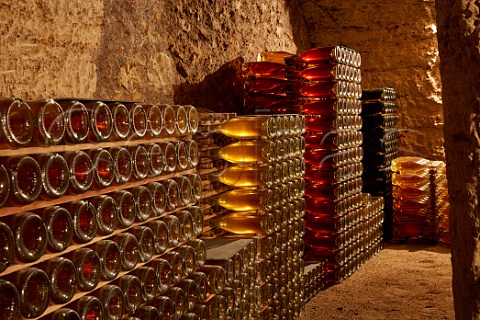 Bottles of wine ageing in cellar of Domaine de la Taille aux Loups which has been dug out of the tuffeau subsoil Husseau IndreetLoire France  MontlouissurLoire