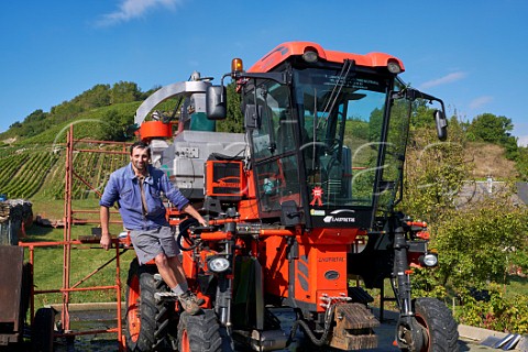 Guy Quenard with harvesting machine  his vineyards are on the hill beyond  Domaine Claude Quenard et Fils Chignin Savoie France