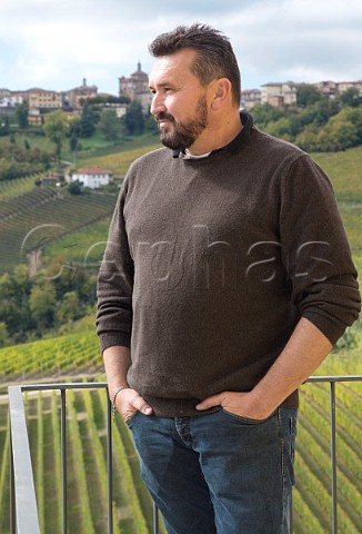 Valter Fissore owner and winemaker on balcony above vineyard of Elvio Cogno with town of Novello beyond  Piedmont Italy  Barolo