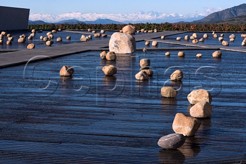 Water and rock art installation at the winery of Via Vik with the Andes in distance Millahue Chile Millahue Valley