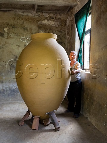 Zaliko Bozhadze master potter puts the finishing touches to a giant qvevri in his studio before it is fired in the kiln Maqatubani or Makatubani Imereti region Georgia Caucasus