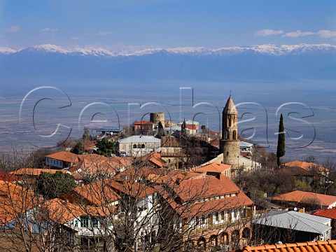 The hilltop town of Sighnaghi above the Alazani Valley wine region with the Caucasus Mountains in distance Kakheti eastern Georgia