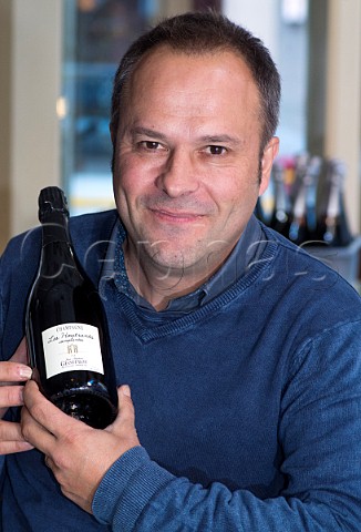 JeanBaptiste Geoffroy with a bottle of his Les Houtrants Champagne Geoffroy Ay Marne France   Valle de la Marne  Champagne