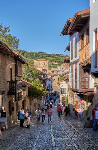 Cobbled street in Santillana del Mar with the Collegiate Church at the end Cantabria Spain