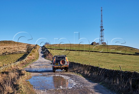 Land Rover on Green Lane by Sir William Hill radio mast Near Bretton Peak District National Park Derbyshire England