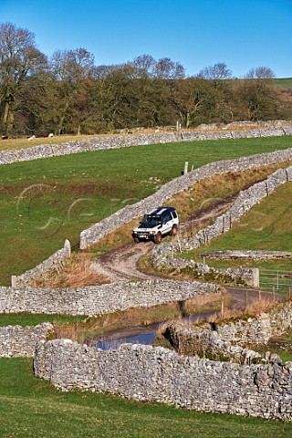 Land Rover on Tideswell Lane a Green Lane near Eyam Peak District National Park Derbyshire England