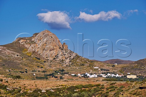 Village of Xinara and the building of the Naxos Tinos Catholic Archdiocese below Mount Exomvourgo Tinos Greece