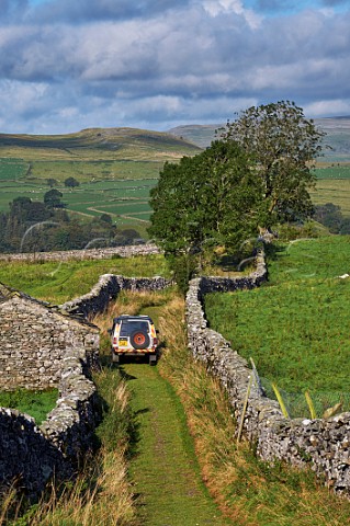 Car on road near Stainforth Yorkshire Dales National Park England