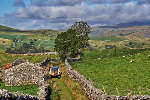 Car on road near Stainforth Yorkshire Dales National Park England