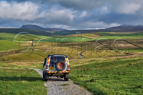 Car on unsurfaced road near Stainforth Yorkshire Dales National Park England