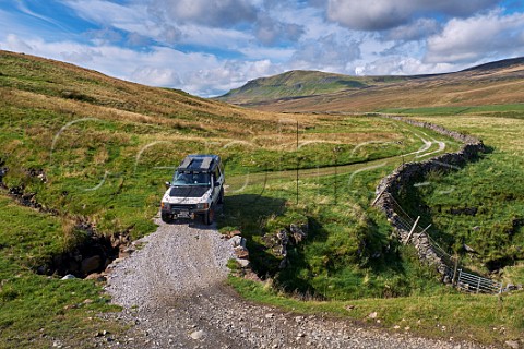 Car on unsurfaced road west of Litton Yorkshire Dales National Park England