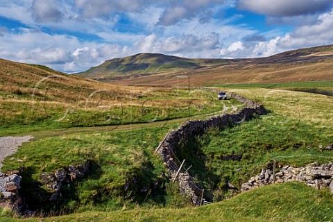 Car on unsurfaced road west of Litton Yorkshire Dales National Park England