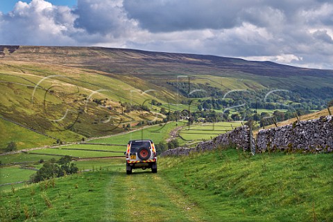 Car on unsurfaced road above Littondale Litton Yorkshire Dales National Park England