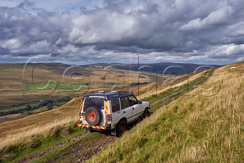 Car on West Cam Road a section of the Pennine Way near Hawes Yorkshire Dales National Park England