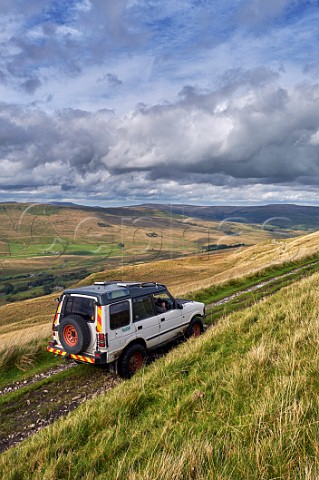 Car on West Cam Road a section of the Pennine Way near Hawes Yorkshire Dales National Park England