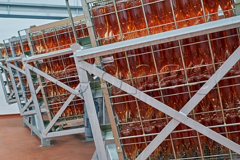 Bottles of Tinwood ros sparkling wine in gyropalettes in the winery of Ridgeview Ditchling Common Sussex England