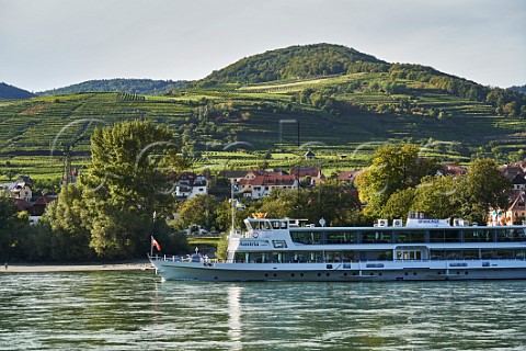 Tourist boat on the Danube with the Achleiten and Klaus vineyards beyond Weissenkirchen Niederosterreich Austria  Wachau