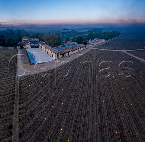 Candles burning in vineyard of Chteau Figeac at dawn during subzero temperatures of 7 April 2021 Stmilion Gironde France Saintmilion Bordeaux