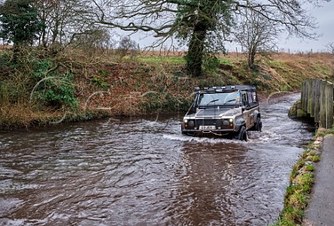 Land Rover fording the River Nar at Castle Acre Norfolk England