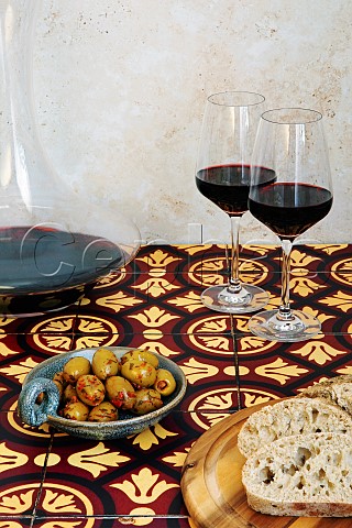 Rioja in a decanter and glasses on a table with bread and olives