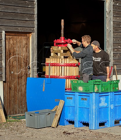 Daniel Ham left adjusting his basket press  Offbeat Wines  Botleys Farm  Downton Wiltshire England