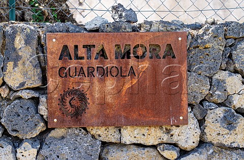 Sign for Alta Mora on volcanic rock wall Contrada Guardiola Sicily Italy  Etna