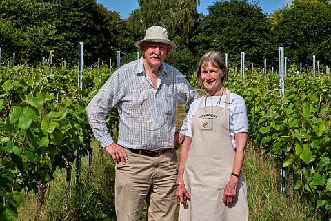 Mark and Cecilia Haszlakiewicz in Pinot Noir vines at Goodworth Clatford Vineyard Goodworth Clatford Hampshire England