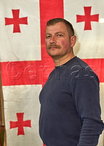Ucha Macharashvili of Ucha wines in front of the Georgian flag Makhatauri Sachkhere Municipality Upper Imereti Georgia