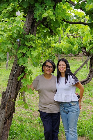Rosanna Petrozziello and her daughter Carla Giusy Favati stand in front of a 200yearold Fiano vine near their winery Cesinali Campania Italy
